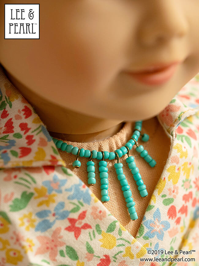 With the techniques and tools we feature in the Lee & Pearl Introduction to Jewelry Making for Vinyl Play Dolls eBook, when you see a style that you like, you can recreate it yourself. Follow along as we show you how we turned a Pinterest inspiration image into this turquoise sunburst choker for 18 inch American Girl® and other dolls!