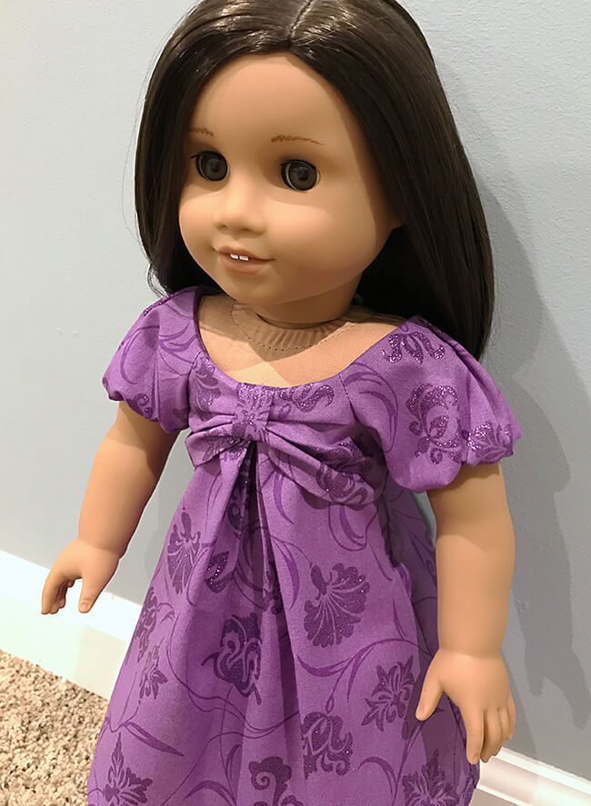 Our FREE GIFT to Lee & Pearl mailing list subscribers — Pattern 1038: The Gift Bow Front Dress for 18 Inch American Girl, 16 Inch A Girl for All Time and 14 1/2 Inch Wellie Wisher and similar dolls. Click to sign up! Amy S. used a subtle purple-on-purple print for her doll's beautiful dress, showing off the pretty pleats and bow front. 