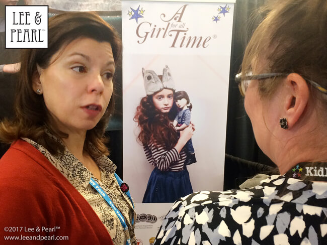 Meet the Dollmaker — Lee & Pearl interview Frances Cain, the creator of the A Girl for All Time® line of historical and modern 16 inch play dolls | Photo: Lee chats with Frances at Toy Fair in New York City