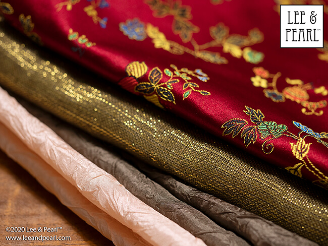 Treat yourself to a surprise fabric gift this holiday season! We're calling our 2020 Lee & Pearl Mystery Bags the SILKEN LUXURY HOLIDAY edition because each bag will contain TWO half yard pieces of shimmering 100% silk dupioni or shantung taffeta, along with materials chosen from our velvets, velveteen, lamé, crinkle rayon, sateen, brocade, faux leather, sequin-studded jersey and anything else we can find that sparkles, rustles, shimmers or shines. Don't wait — once this edition is SOLD OUT, you'll have to wait for the next sale in 2021.