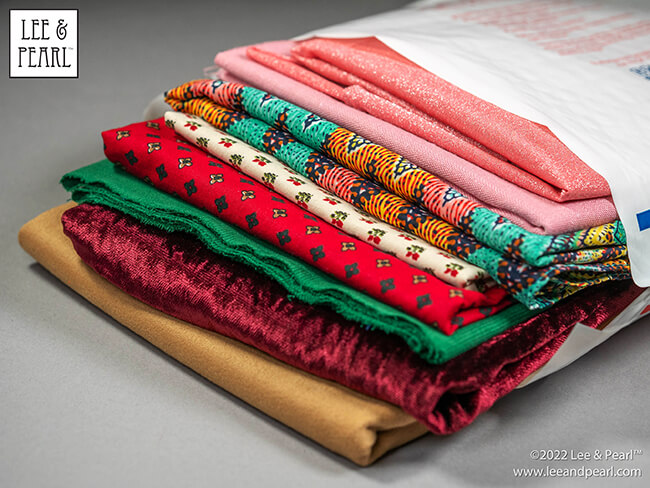 It's Mystery Bag Day! The 2022 Lee & Pearl Fabric Mystery Bags arrive in our Etsy store at 12 noon central on Friday, 12/02/22.
You've been so good all year and now you deserve something special. That's why we've tucked so many special things into each of our 2022 Lee & Pearl Fabric Mystery Bags.
Don't wait too long to check out and give yourself the gift of beautiful fabric. This year we have two special, limited edition Mystery Bags that also include BONUS PACK options, as well as our standard treat bags stuffed with beautiful fabrics for doll sewing!