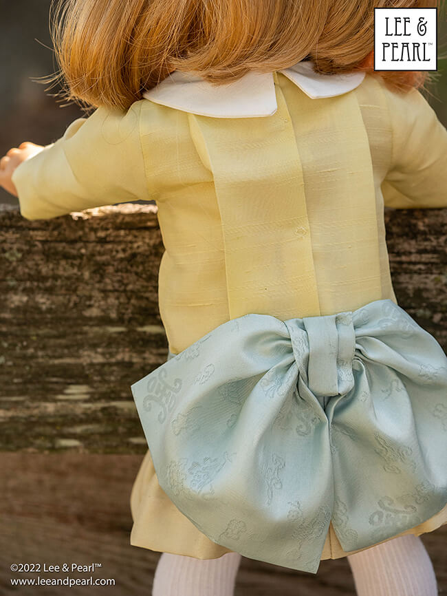 Happy Easter from Lee & Pearl! In this holiday pictorial, join our American Girl® doll Nellie as she explores a hidden garden, dressed in a lovely silk dress embellished with ribbons and bows, accompanied by seasonal props from our FREE tutorial and printable collection and the craft store floral and spring decor aisles.