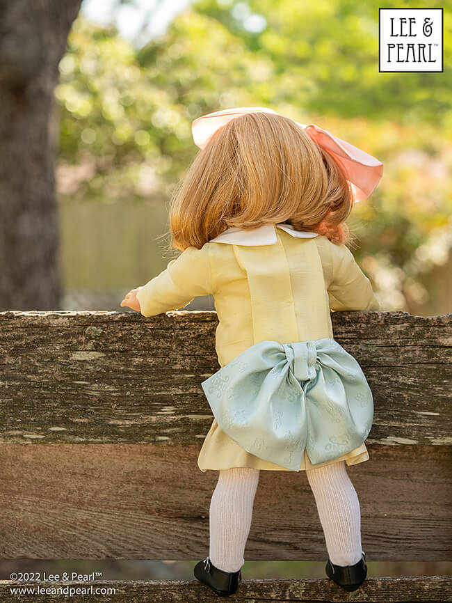 Happy Easter from Lee & Pearl! In this holiday pictorial, join our American Girl® doll Nellie as she explores a hidden garden, dressed in a lovely silk dress embellished with ribbons and bows, accompanied by seasonal props from our FREE tutorial and printable collection and the craft store floral and spring decor aisles.