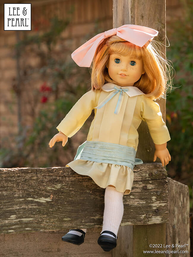 Happy Easter from Lee & Pearl! In this holiday pictorial, join our American Girl® doll Nellie as she explores a hidden garden, dressed in a lovely silk dress embellished with ribbons and bows, accompanied by seasonal props from our FREE tutorial and printable collection and the craft store floral and spring decor aisles.