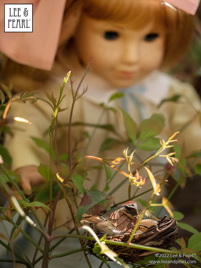 Happy Easter from Lee & Pearl! In this holiday pictorial, join our American Girl® doll Nellie as she explores a hidden garden, dressed in a lovely silk dress embellished with ribbons and bows, accompanied by seasonal props from our FREE tutorial and printable collection and the craft store floral and spring decor aisles.