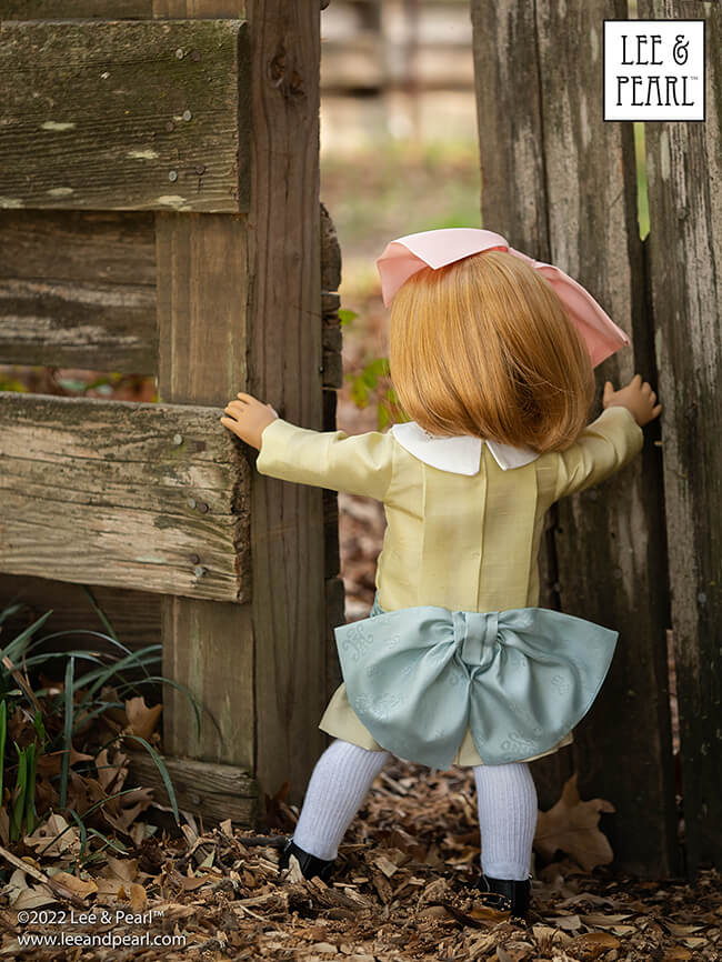 Happy Easter from Lee & Pearl! In this holiday pictorial, join our American Girl® doll Nellie as she explores a hidden garden, dressed in a lovely silk dress embellished with ribbons and bows, accompanied by seasonal props from our FREE tutorial and printable collection and the craft store floral and spring decor aisles.