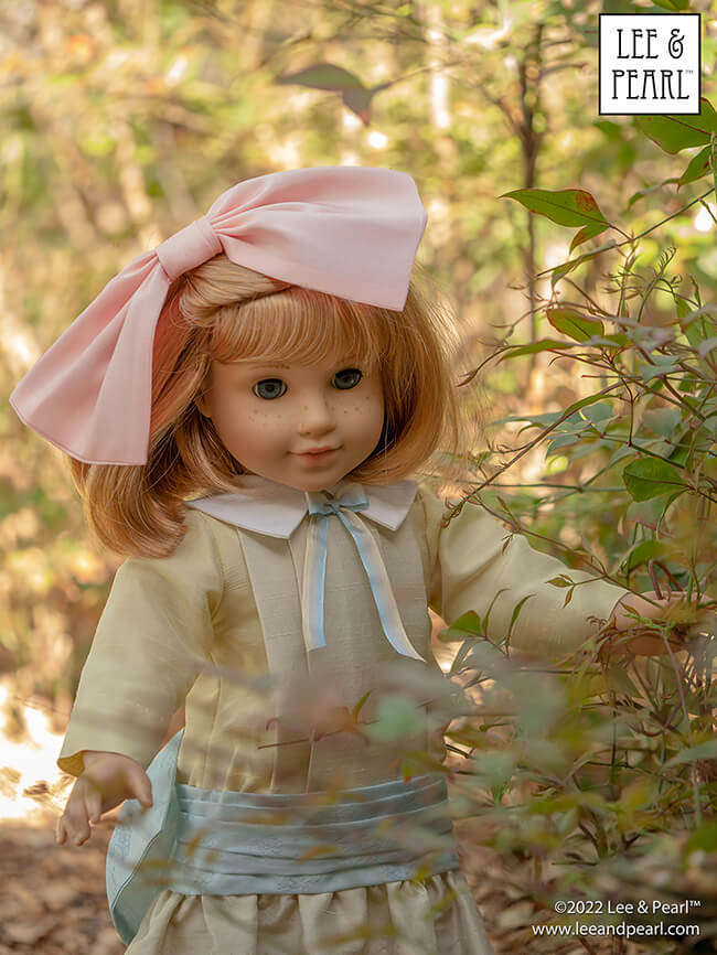 Happy Easter from Lee & Pearl! In this holiday pictorial, join our American Girl® doll Nellie as she explores a hidden garden, dressed in a lovely silk dress embellished with ribbons and bows, accompanied by seasonal props from our FREE tutorial and printable collection and the craft store floral and spring decor aisles.