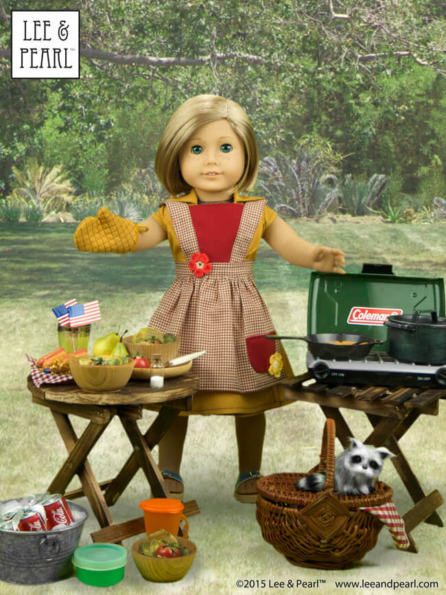 Happy July 4th! Our American Girl™ Kit has everything ready for the picnic. Kit's wearing a sunny yellow cotton wrap dress from Lee & Pearl Pattern #1031: Classic Wrap Dress and Peplum Top for 18" Dolls. Her gingham apron and diamond-stitched oven mitt come from L&P Pattern #1022: Cookie Time Apron, Pinafore and Oven Mitt for 18" Dolls. These patterns are available in our Etsy shop at https://www.etsy.com/shop/leeandpearl