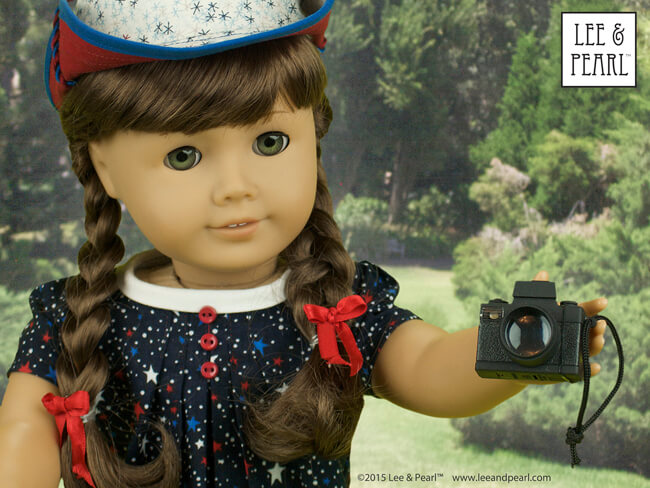 It can't be the Fourth of July without American Girl™ Molly!Our spirited girl looks every inch the patriot in a star-spangled dress made using Lee & Pearl Pattern #1033: Bonjour, Paris Mini Wardrobe for 18" Dolls and her jaunty sunhat was made using L&P #1007: Bush Hat or "Boonie" for 18" Dolls. These patterns are available in our Etsy shop at https://www.etsy.com/shop/leeandpearl Molly's tiny camera is a Kikkerland LED keychain — a must-have dolly accessory in our book.